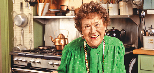 Portrait en gros plan de Julia Child souriante, avec une blouse verte
